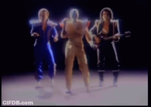 A Group Of People Are Standing Next To Each Other And One Of Them Is Holding A Guitar . GIF