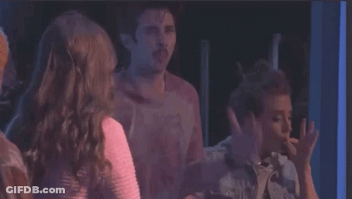A Group Of People Are Standing Next To Each Other And One Of Them Is Saying You 'Re Either In The Smoke Club GIF