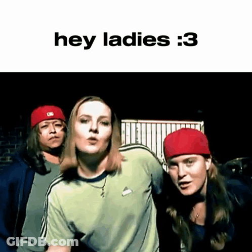 A Group Of People Are Standing Next To Each Other And One Of Them Is Wearing A Red Hat And A Green Shirt . GIF