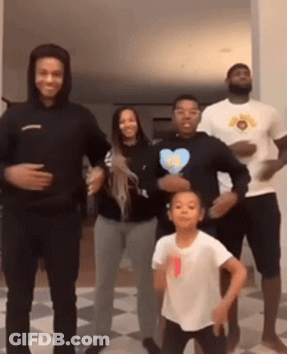 A Group Of People Are Standing Next To Each Other Dancing . GIF