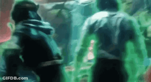 A Group Of People Are Standing Next To Each Other In A Dark Room With Green Lights Coming Out Of Them . GIF