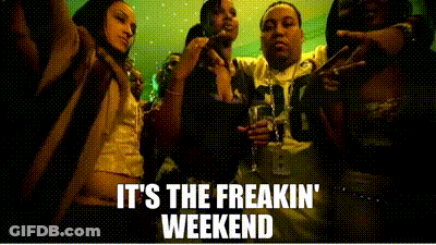 A Group Of People Are Standing Next To Each Other In A Dark Room . GIF