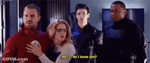 A Group Of People Are Standing Next To Each Other In A Room And A Woman Is Holding A Man 'S Hand . GIF