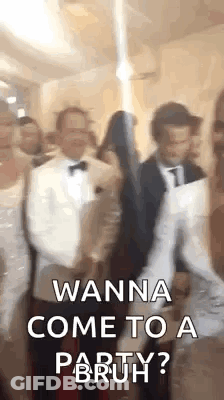 A Group Of People Are Standing Next To Each Other In A Room And One Of Them Is Holding A Gun . GIF