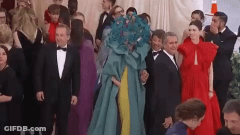 A Group Of People Are Standing Next To Each Other In A Room At A Party . GIF