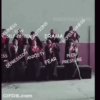 A Group Of People Are Standing Next To Each Other In A Room With A Lot Of Words On Them . GIF
