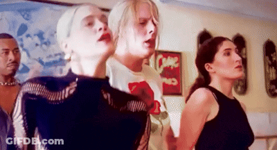 A Group Of People Are Standing Next To Each Other In A Room With A Sign That Says Come On . GIF