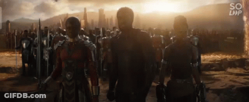A Group Of People Are Standing Next To Each Other In Front Of A City . GIF