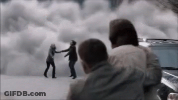 A Group Of People Are Standing Next To Each Other In Front Of A Cloudy Sky . GIF
