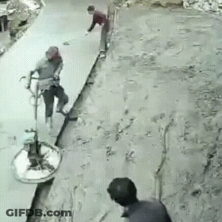 A Group Of People Are Standing On A Concrete Surface . GIF
