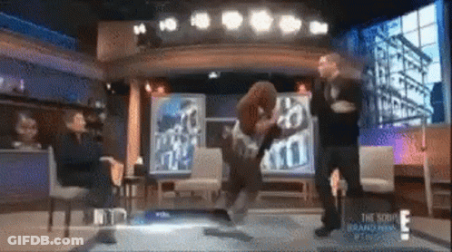 A Group Of People Are Standing On A Stage In Front Of A Sign That Says ' The Show ' On It . GIF