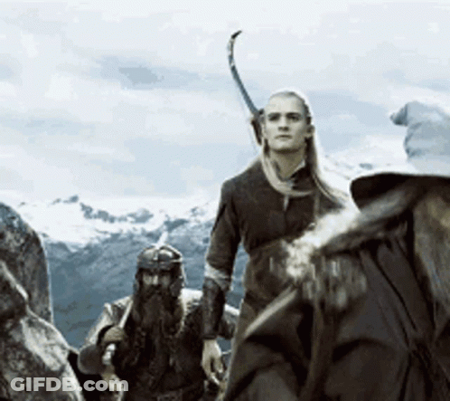 A Group Of People Are Standing On Top Of A Mountain With A Sword In Their Hand GIF