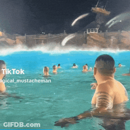 A Group Of People Are Swimming In A Pool At Night With A Caption That Says Tiktok Magical Mustacheman GIF