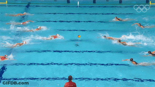 A Group Of People Are Swimming In A Pool With The Olympic Rings On The Wall GIF