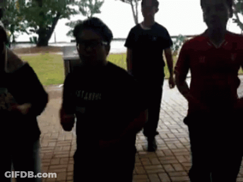 A Group Of People Are Walking Down A Brick Walkway And One Of Them Is Wearing A Shirt That Says Istanbul GIF