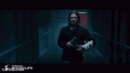 A Group Of People Are Walking Down A Dark Hallway With A Fandango Movieclips Logo On The Bottom GIF