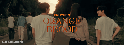A Group Of People Are Walking Down A Road And The Words Orange Blood Are On The Bottom GIF
