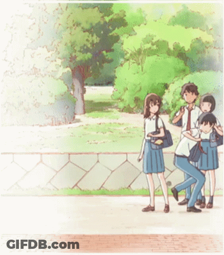 A Group Of People Are Walking Down A Sidewalk In A Park GIF