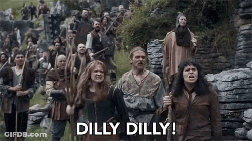 A Group Of People Are Walking In A Field With The Words Dilly Dilly Written On The Bottom . GIF
