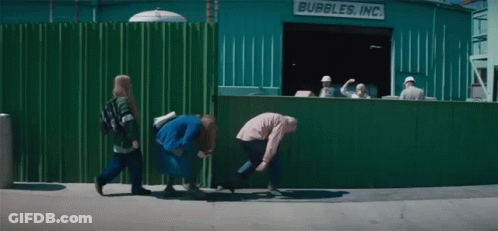 A Group Of People Are Walking In Front Of A Bubbles Inc. Building GIF