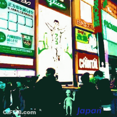 A Group Of People Are Walking In Front Of A Sign That Says Japan GIF