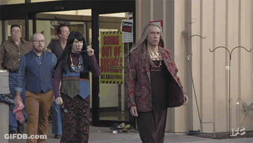 A Group Of People Are Walking In Front Of A Store With A Sign That Says Going Out Of Business GIF