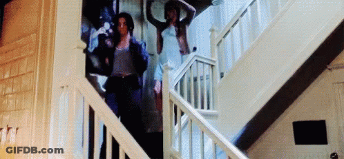 A Group Of People Are Walking Up A Set Of Stairs . GIF