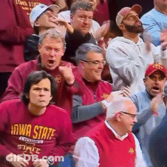 A Group Of People Are Watching A Basketball Game And One Of Them Is Wearing A Iowa State Shirt GIF