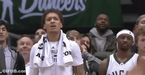 A Group Of People Are Watching A Basketball Game . GIF