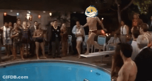 A Group Of People Are Watching A Man Jump Into A Swimming Pool With A Mascot On His Head GIF