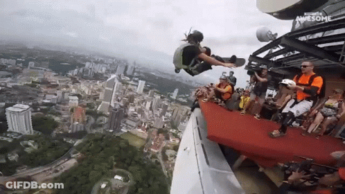 A Group Of People Are Watching A Person Jump Off A Building And The Words Awesome Are On The Bottom Right GIF