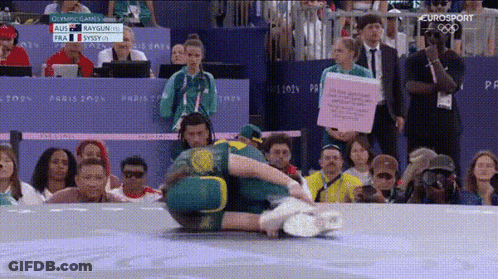 A Group Of People Are Watching A Wrestling Match With The Eurosport Logo In The Corner GIF