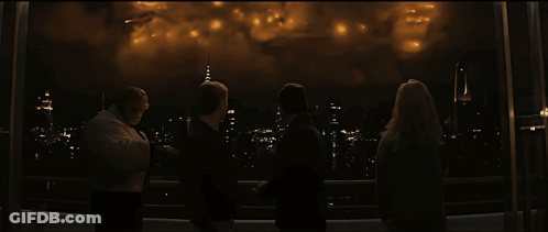 A Group Of People Are Watching Fireworks Over A City At Night GIF