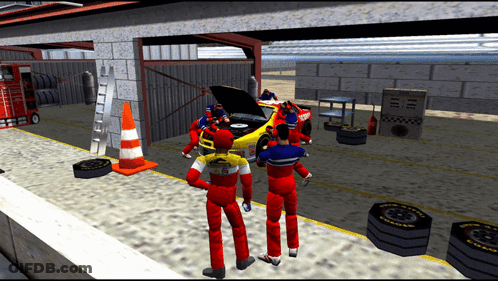 A Group Of People Are Working On A Race Car In A Garage With Good Year Tires GIF