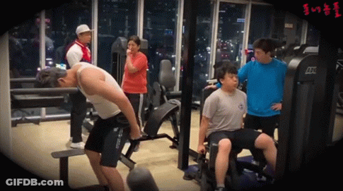 A Group Of People Are Working Out In A Gym With A Machine That Says Atx GIF