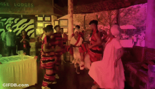 A Group Of People Dancing In Front Of A Sign That Says Royal Lodges GIF
