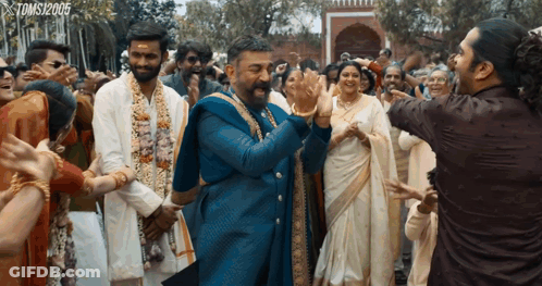 A Group Of People Dancing In Front Of A Sign That Says Toms120905 GIF