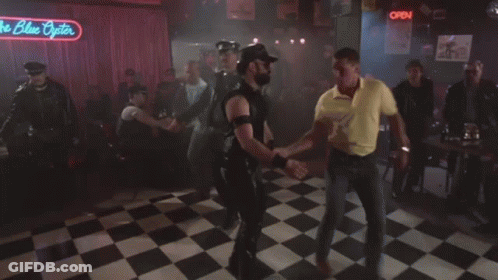 A Group Of People Dancing Under A Neon Sign That Says The Blue Pointer GIF