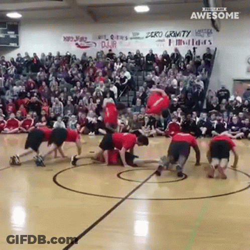 A Group Of People Doing Push Ups On A Basketball Court With A Sign That Says Zero Gravity GIF