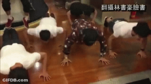 A Group Of People Doing Push Ups On The Floor With Chinese Writing On The Bottom GIF