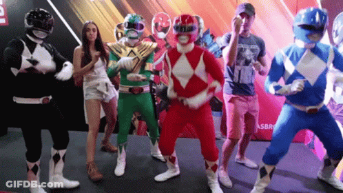 A Group Of People Dressed As Power Rangers Are Dancing Together GIF