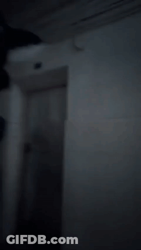 A Group Of People Dressed As Tom And Jerry Are Walking Down A Dark Hallway GIF