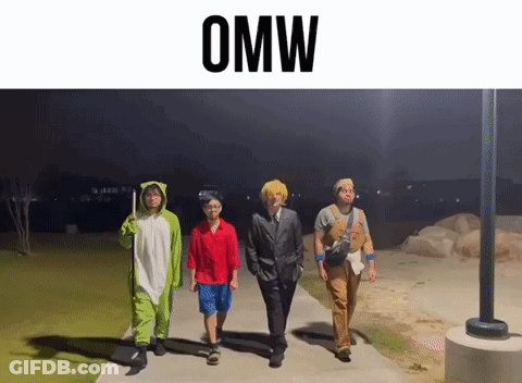 A Group Of People Dressed In Costumes Are Walking Down A Sidewalk And The Word Omw Is Above Them GIF