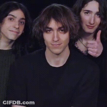 A Group Of People Giving A Thumbs Up Sign GIF
