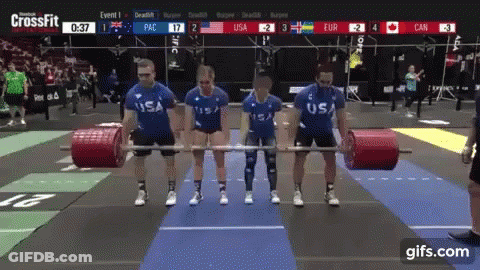A Group Of People Holding Barbells In Front Of A Screen That Says Crossfit On It GIF
