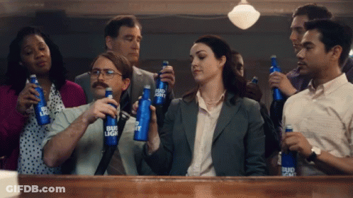 A Group Of People Holding Bud Light Bottles In Their Hands GIF