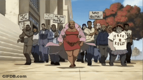 A Group Of People Holding Signs That Say Free R Kelly GIF