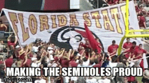 A Group Of People Holding Up A Banner That Says Florida State Making The Seminoles Proud GIF
