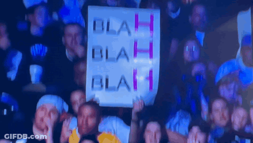 A Group Of People Holding Up A Sign That Says Blah Blah Blah GIF
