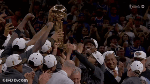 A Group Of People Holding Up A Trophy That Says Finals On The Bottom GIF